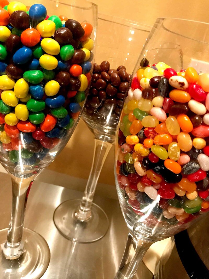Wine glasses filled with different candies