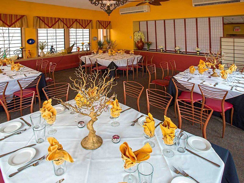 Terrazzo room with white table cloths, gold napkins and golden center pieces