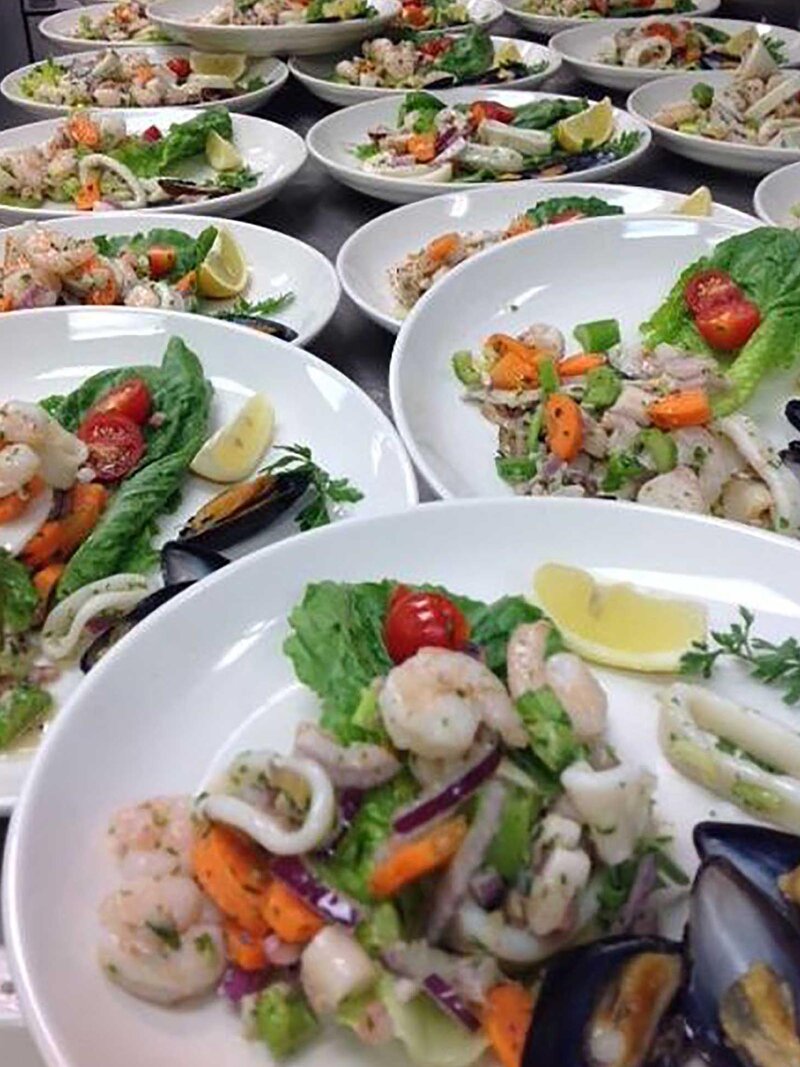 Many plated shrimp salads